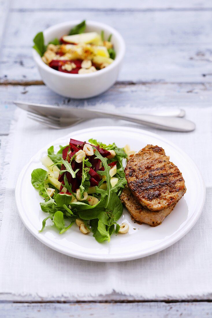 Grilled pork loin with rocket and beetroot salad, apple