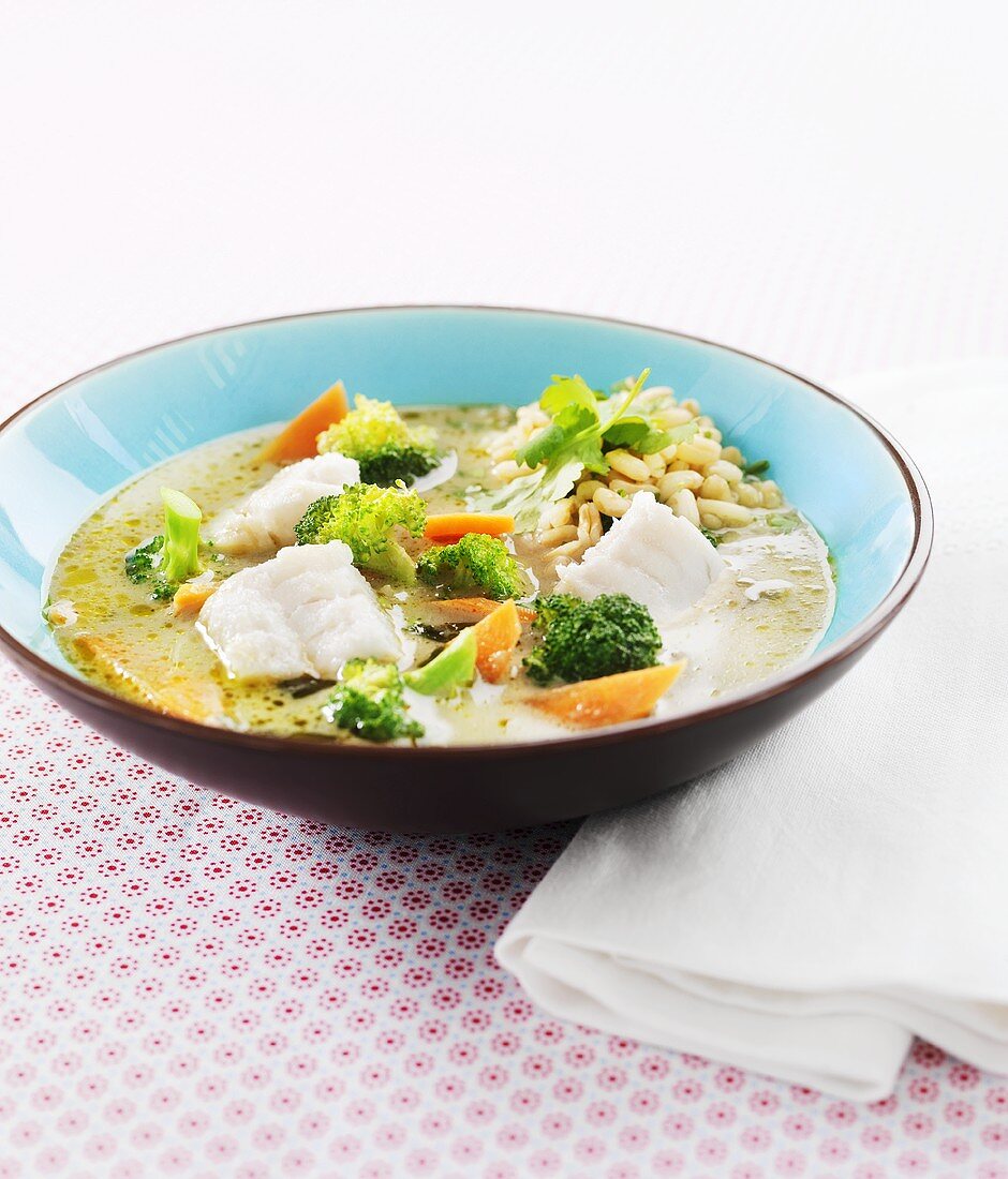 Fish soup with broccoli, carrots and pine nuts