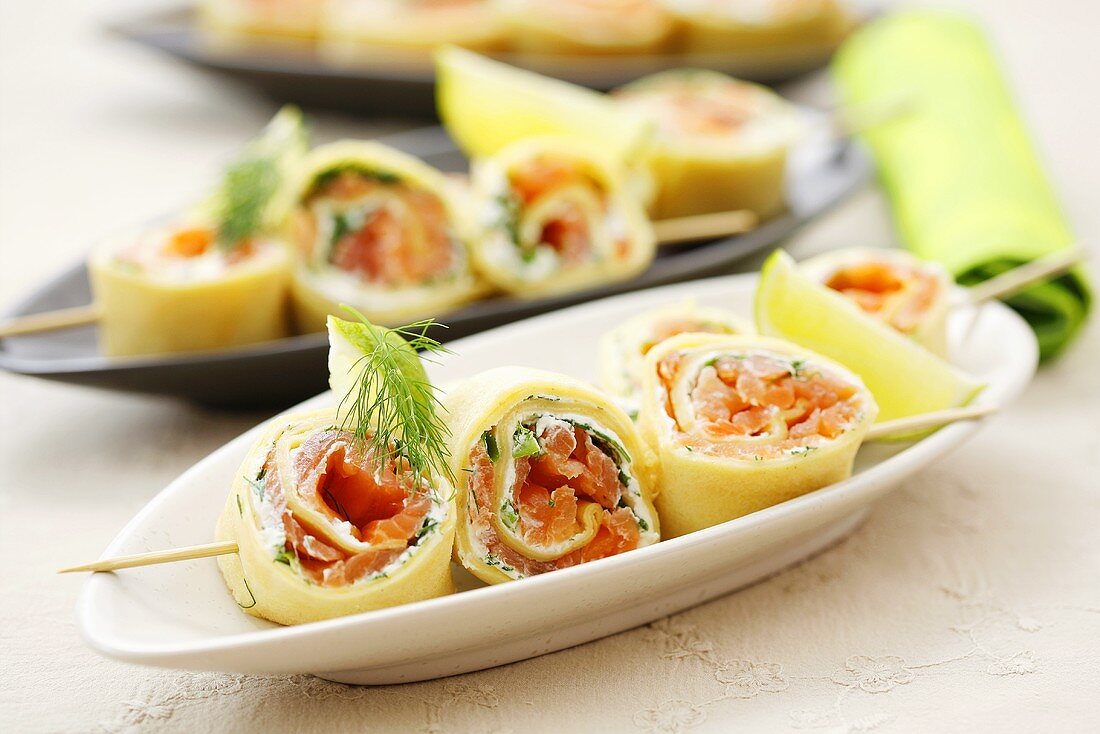 Pancake rolls with dill cream & smoked salmon filling on skewers