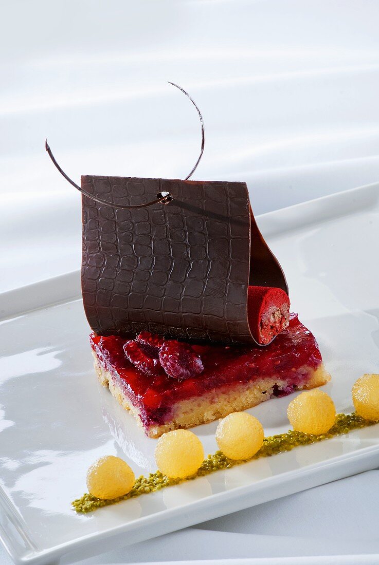 Raspberry slice with chocolate and garnish of pear balls