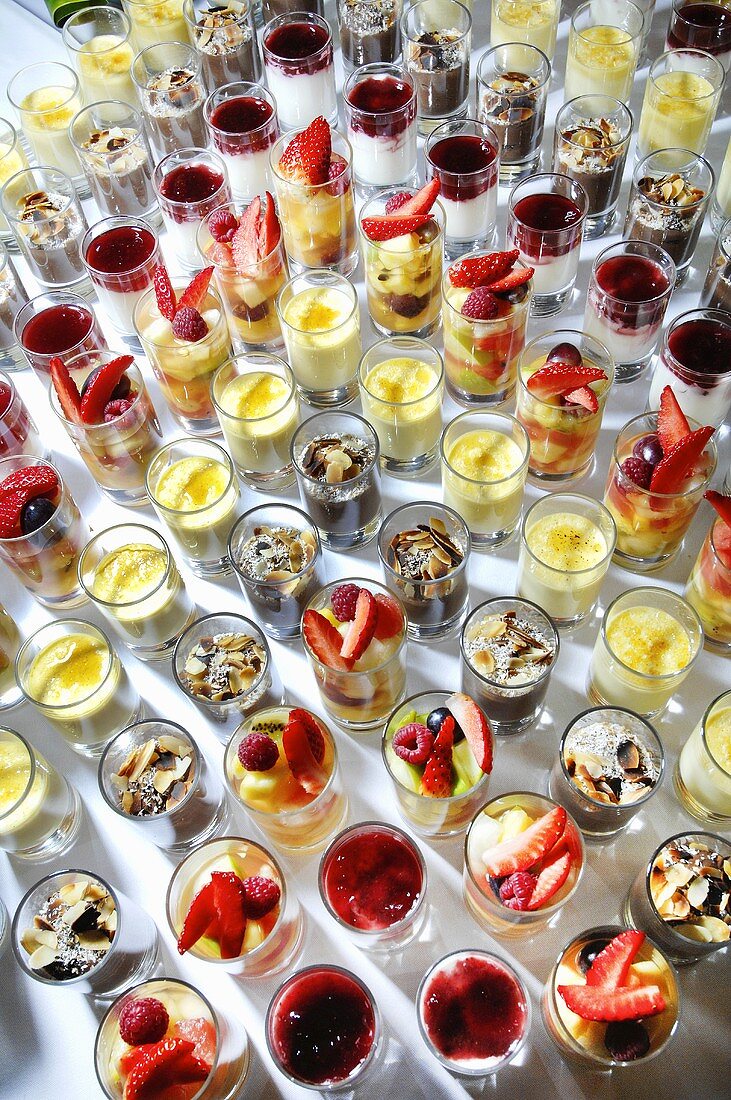 Many party desserts in glasses