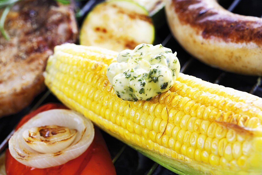 Corn on the cob with herb butter on barbecue