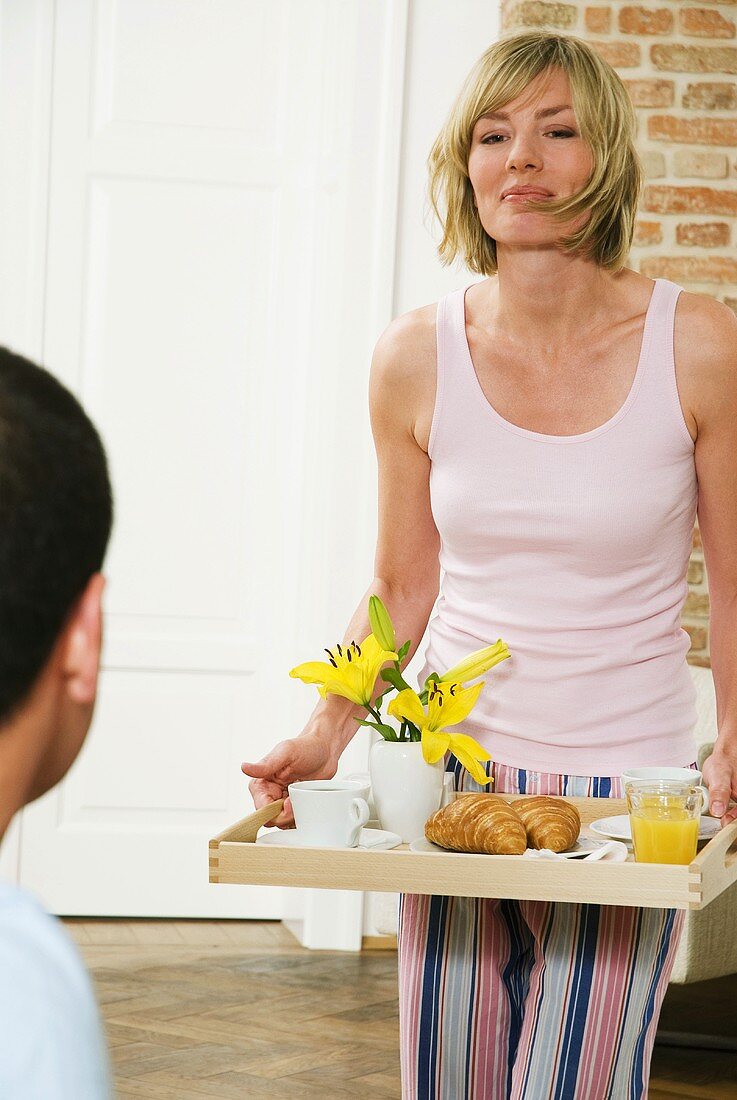 Young woman serving breakfast, close-up