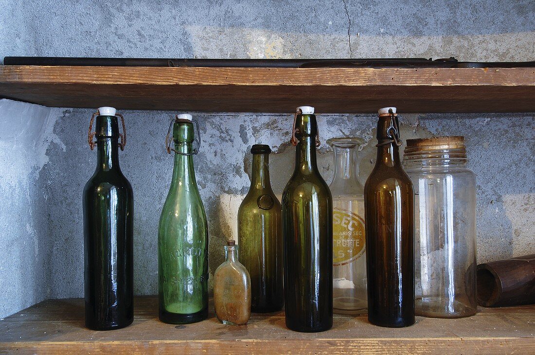 Assorted empty bottles on shelf