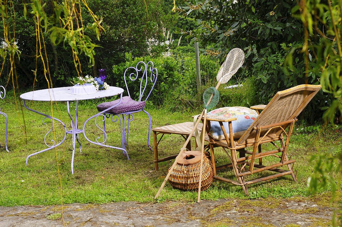 Lounger, fishing nets, creel, garden table and chair