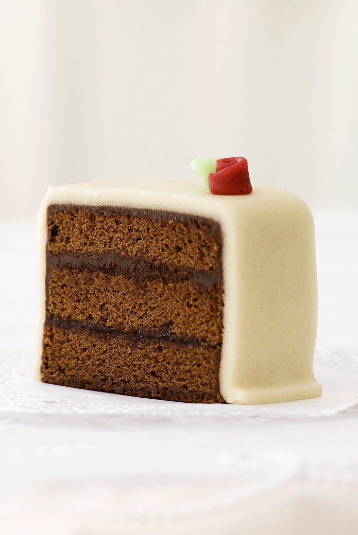 Piece of chocolate cake with marzipan coating