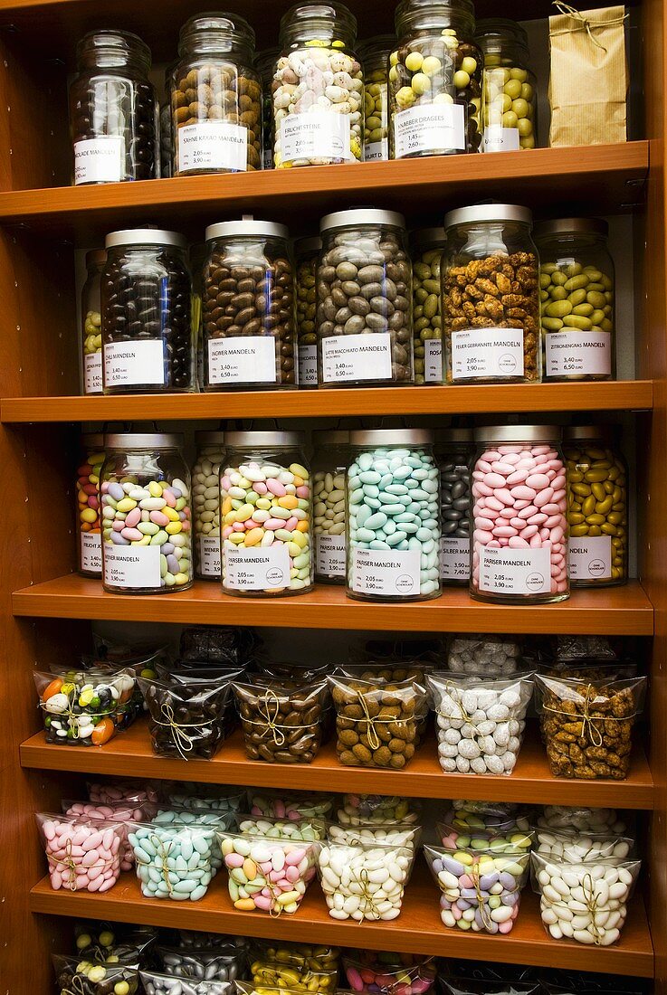 Sugared almonds of various colours on shelves