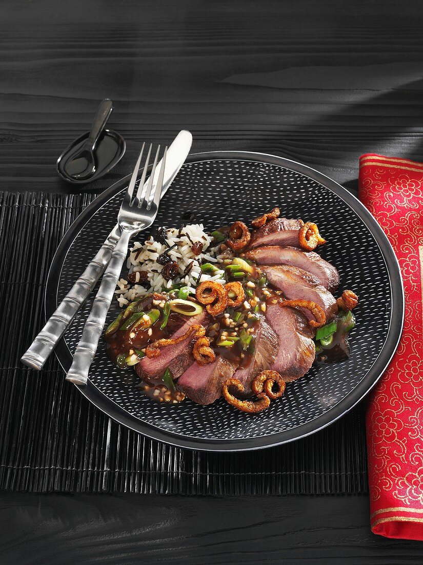 Roast duck breast with almonds, ginger and rice