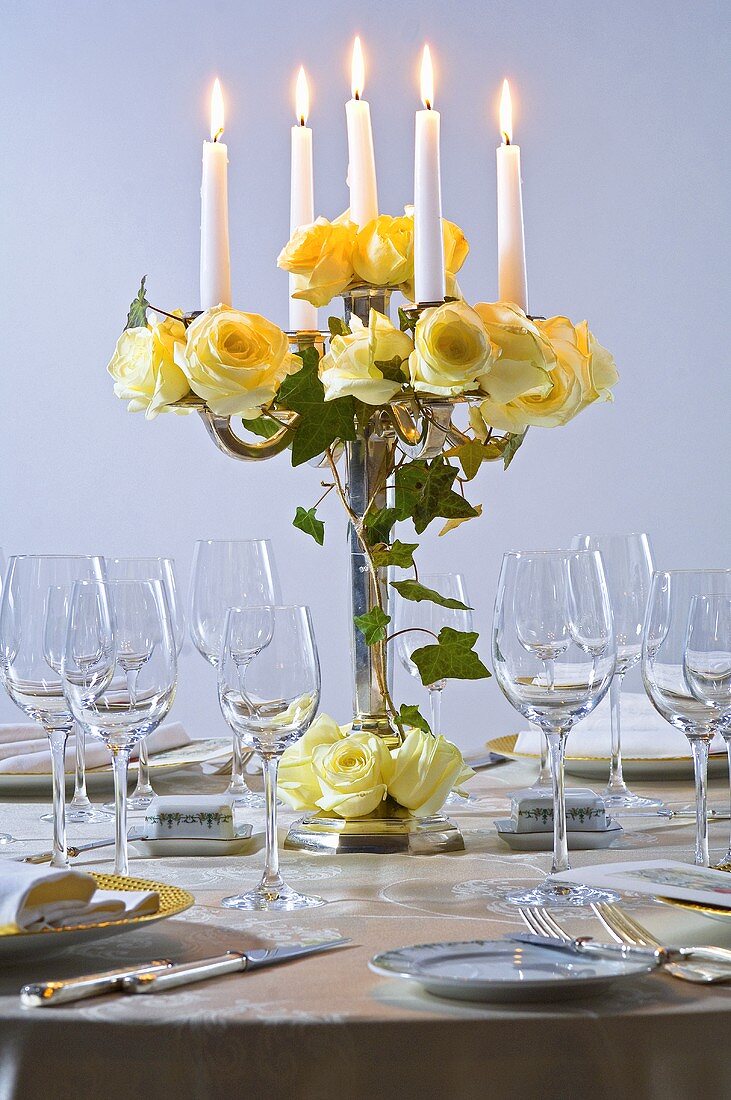 Candelabrum with yellow roses and ivy