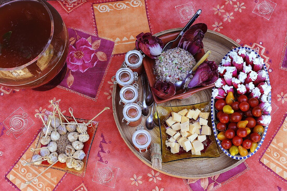 Appetiser platter: marinated quails' eggs, cherry tomatoes, stuffed radishes