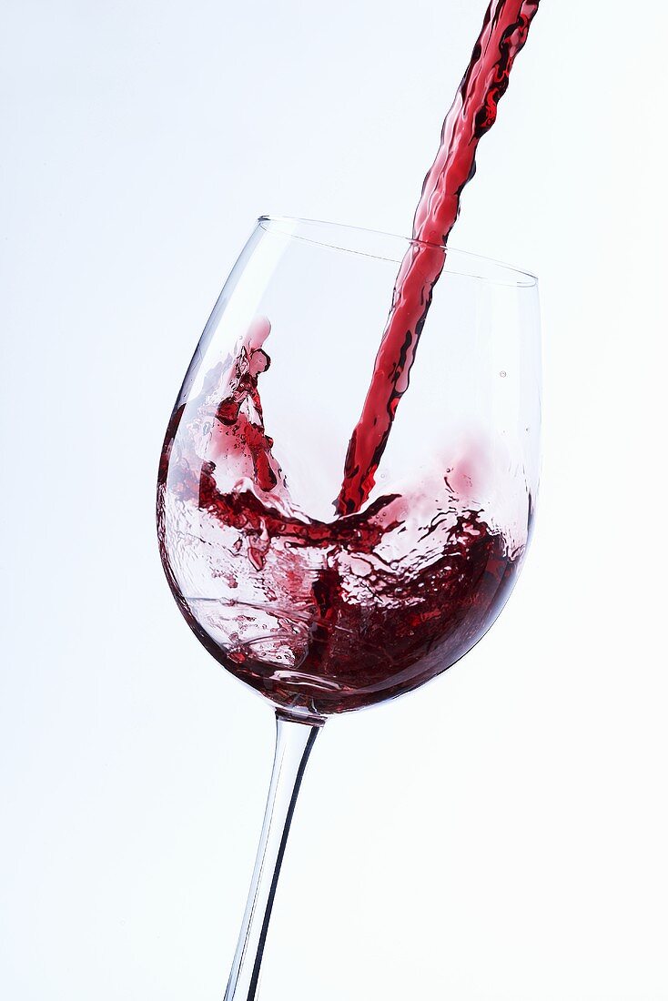 Pouring red wine into a glass