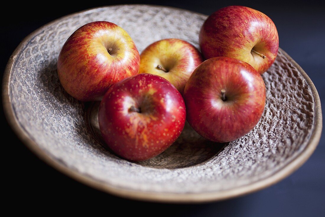 Several red apples on plate