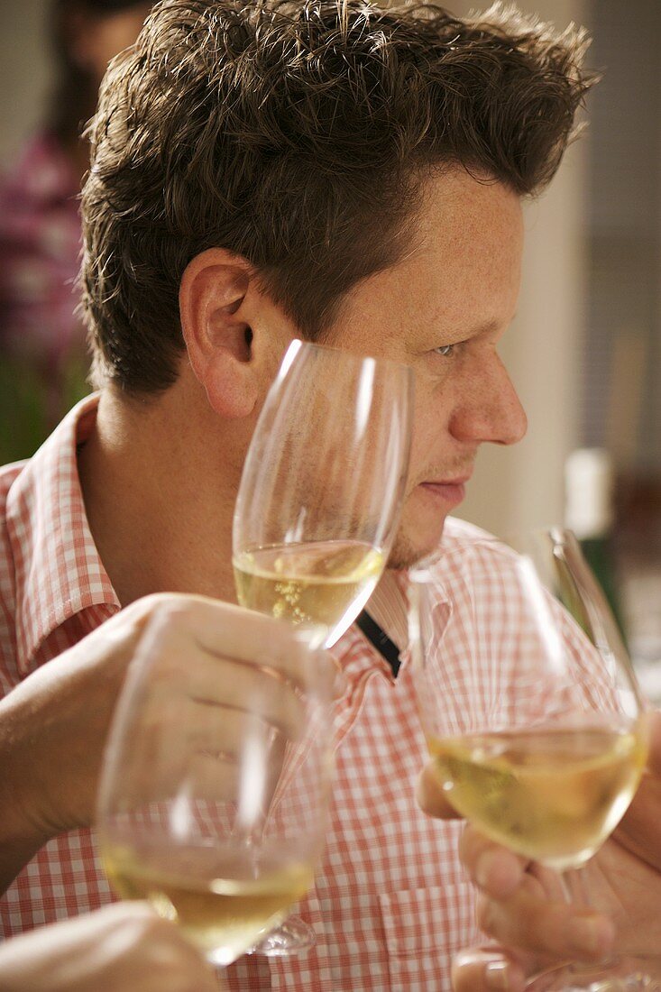 Man raising a glass of sparkling wine