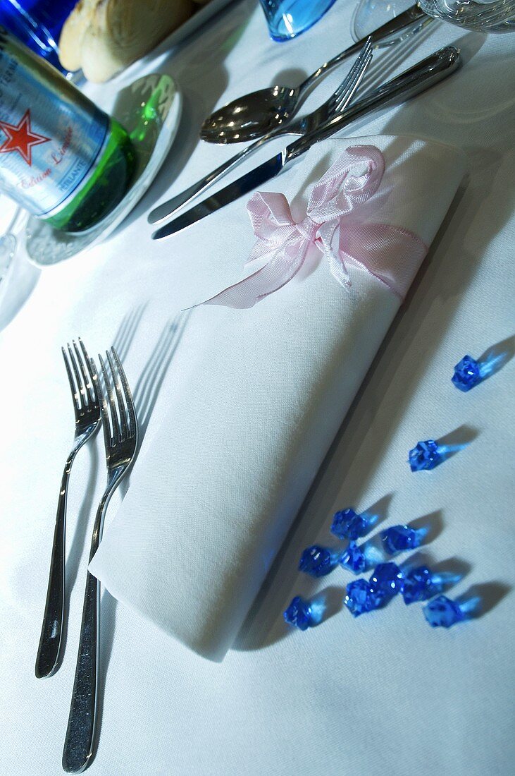 Place-setting with fabric napkin and blue glass gems