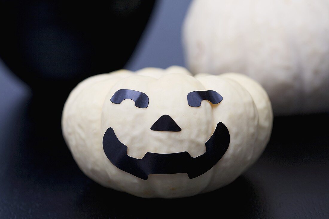 White pumpkin with face for Halloween