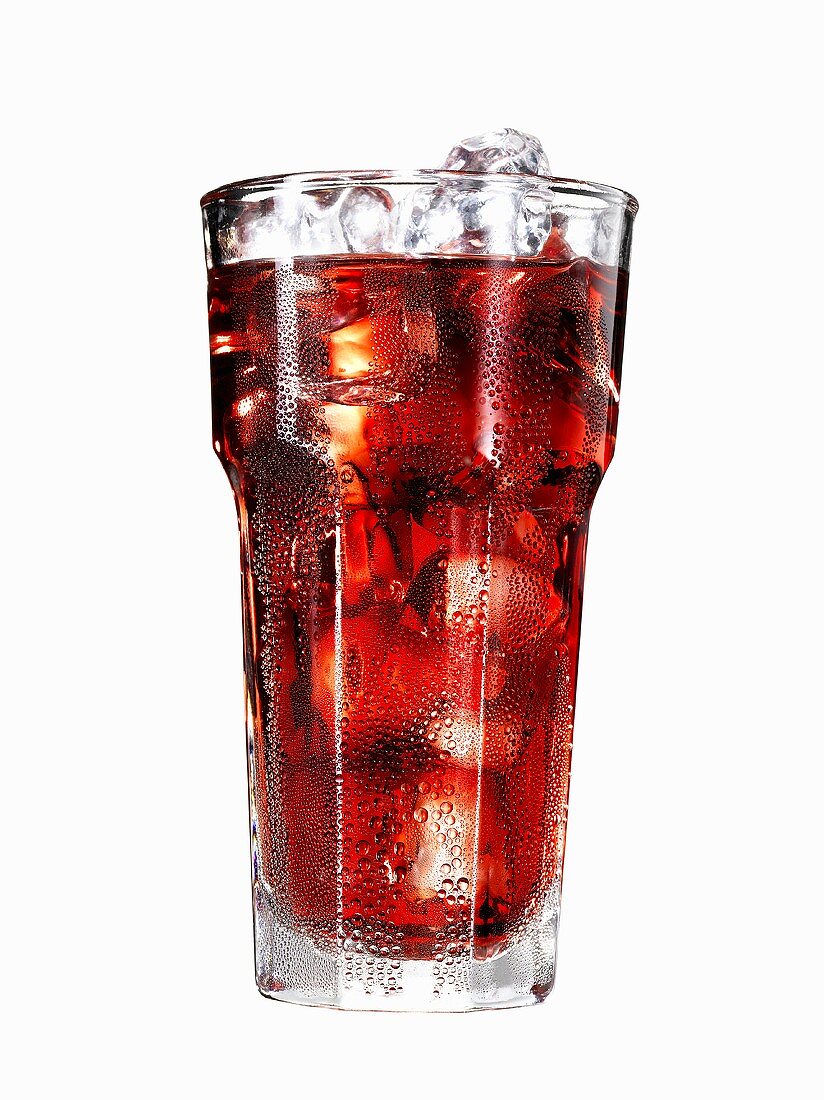 Glass of cranberry juice with ice cubes (with condensation)