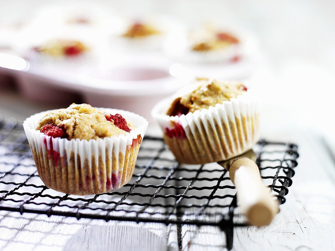 Raspberry and banana muffins on cake rack