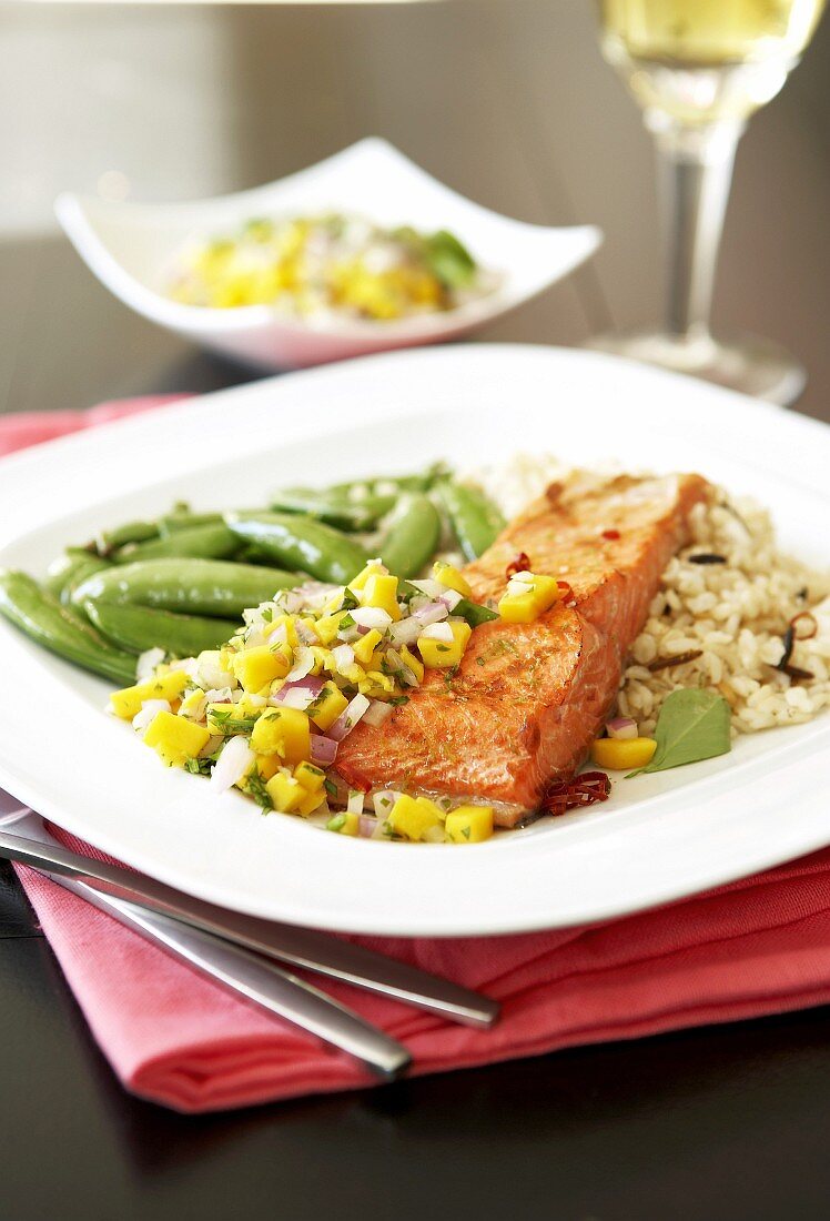 Grilled salmon fillet with mango salsa, green beans and rice