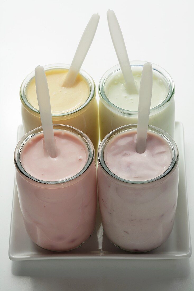 Four different fruit yoghurts in jars