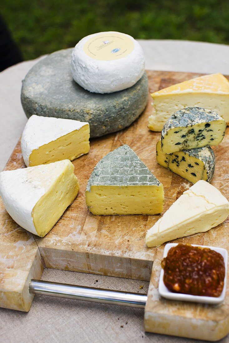 Various organic cheeses on chopping board