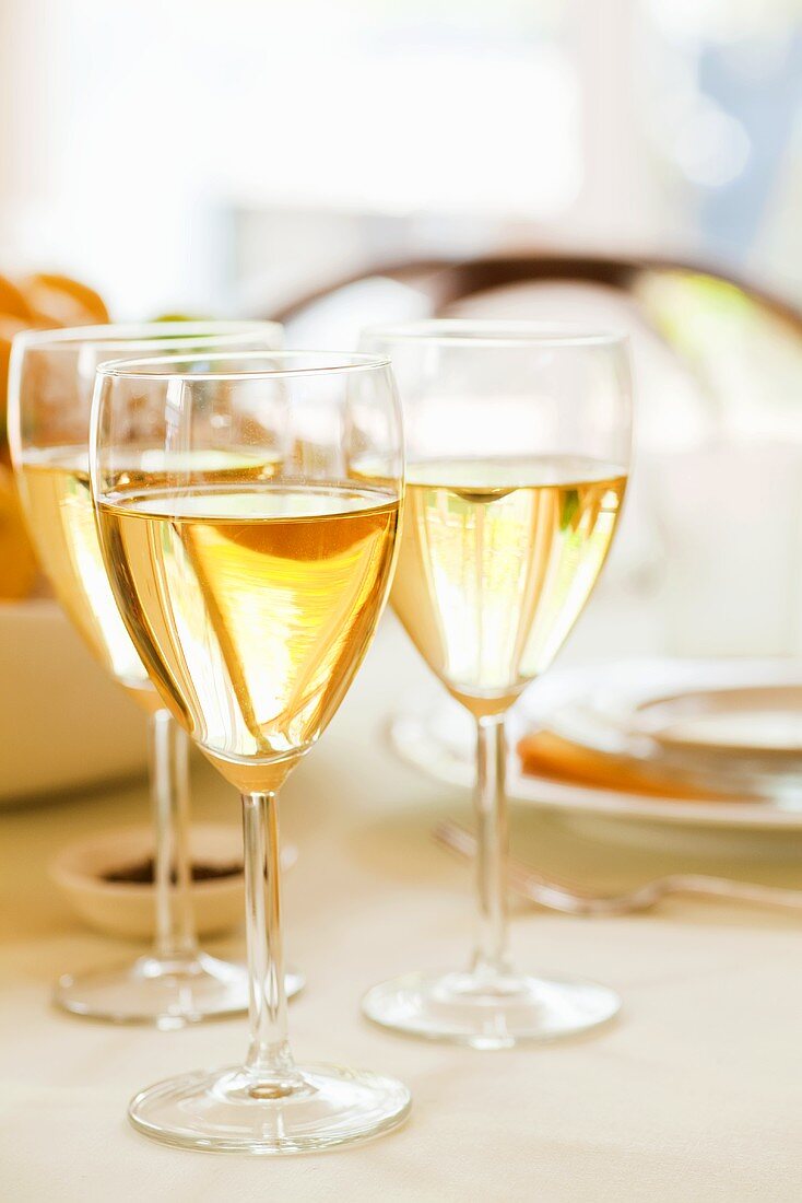 Glasses of white wine on laid table