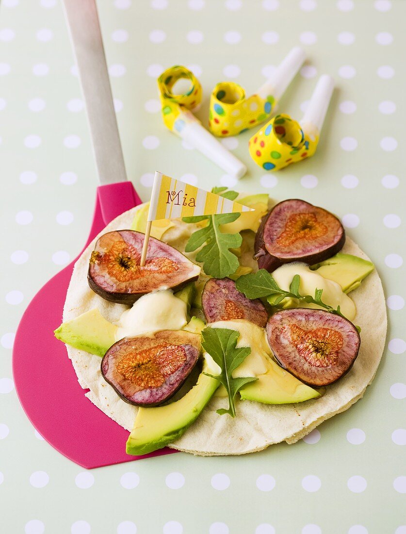 Flatbread pizza topped with figs and avocado for children