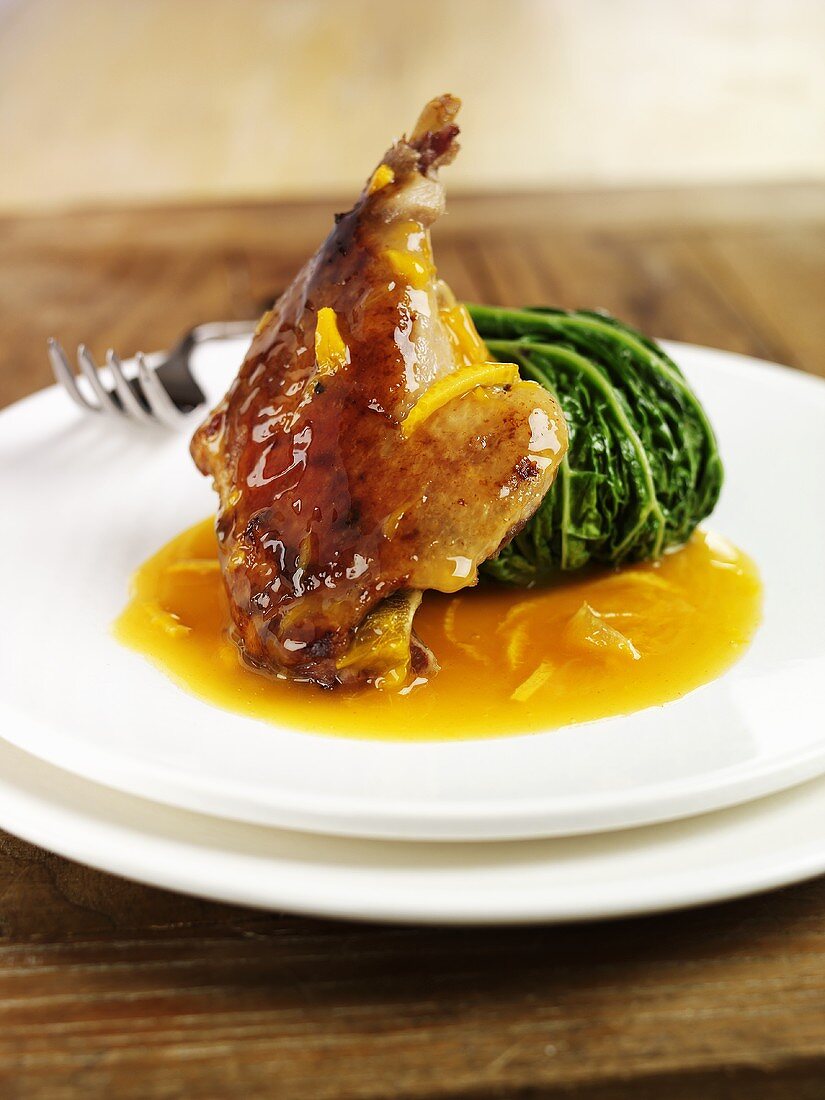 Duck with orange sauce and stuffed savoy cabbage leaf