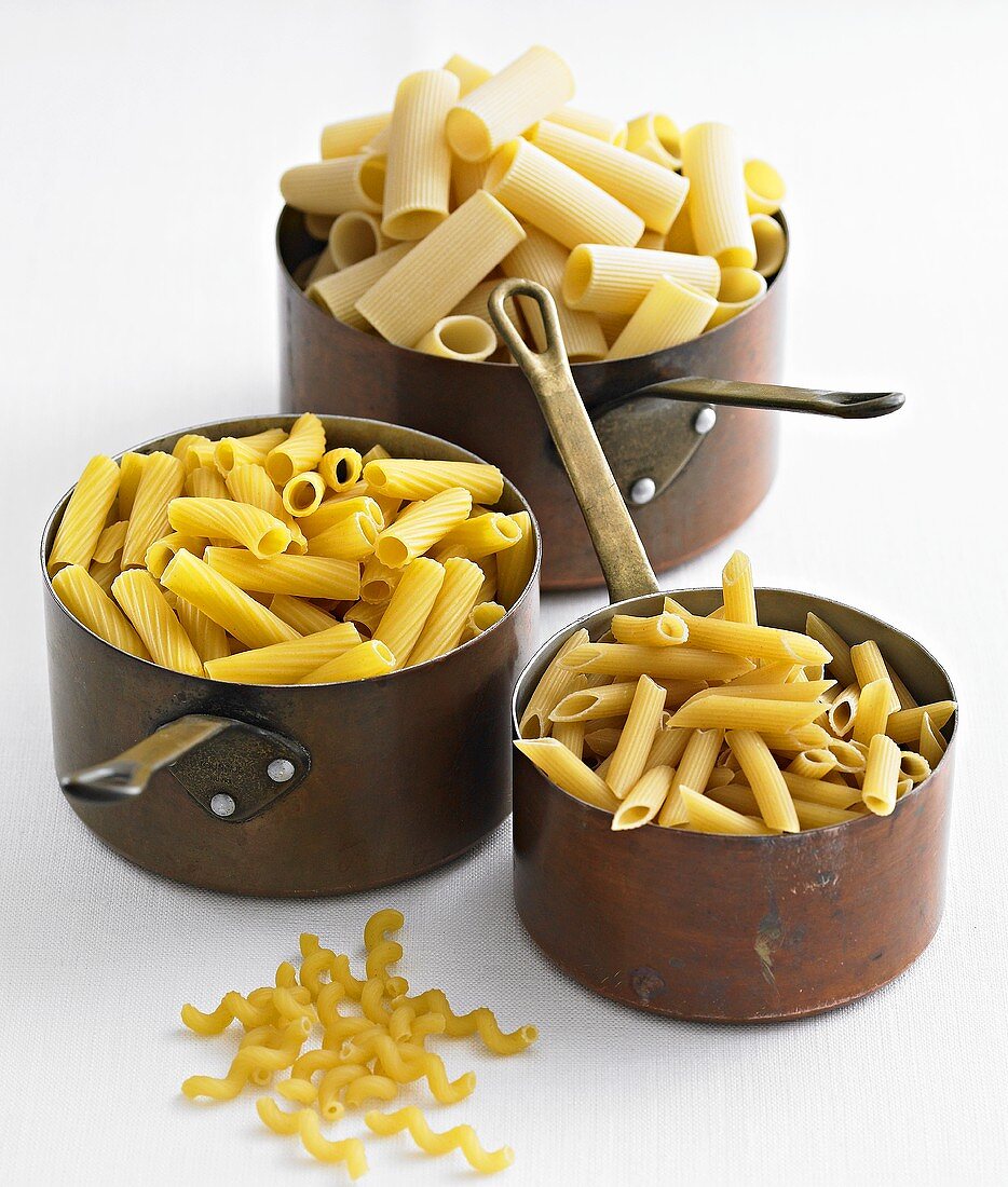 Various types of pasta in pans