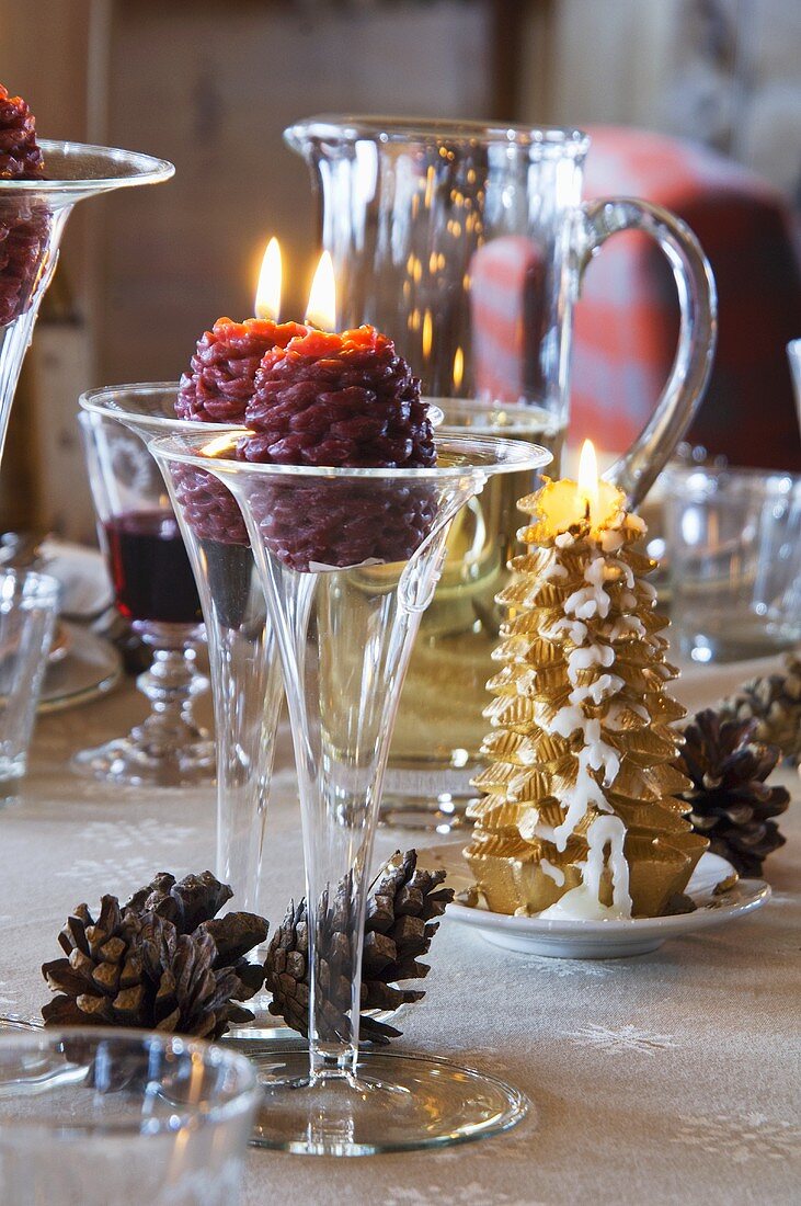 Verschiedene Kerzen auf weihnachtlichem Tisch