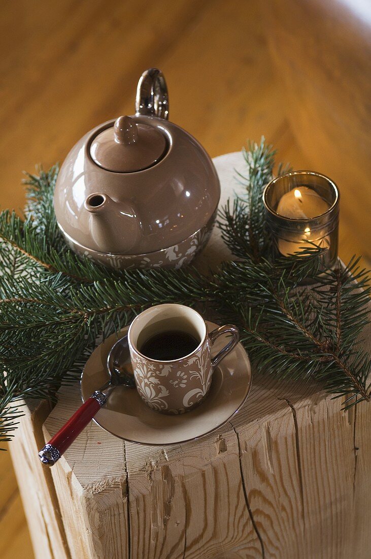 Cup of tea and teapot with Christmas decorations