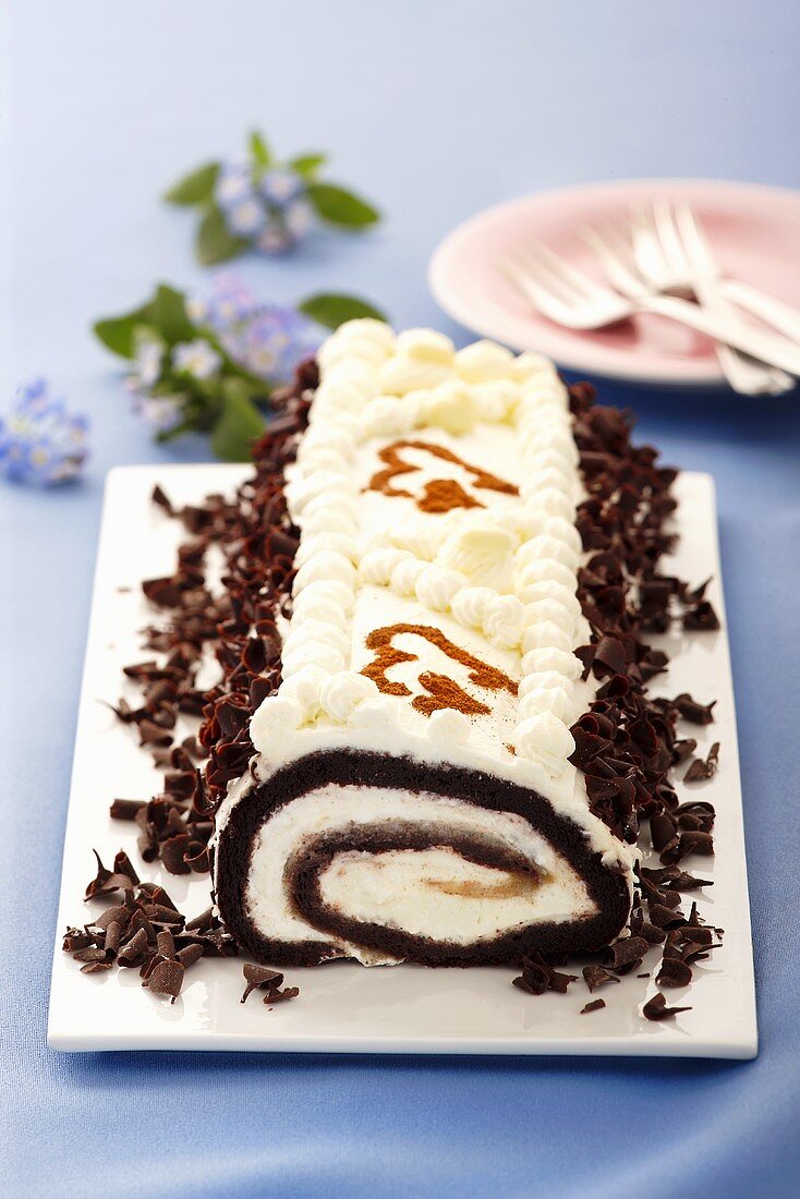 Chocolate roll with cream filling and grated chocolate