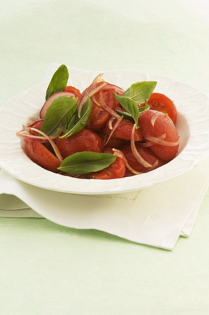 Poached tomato salad with onions and basil