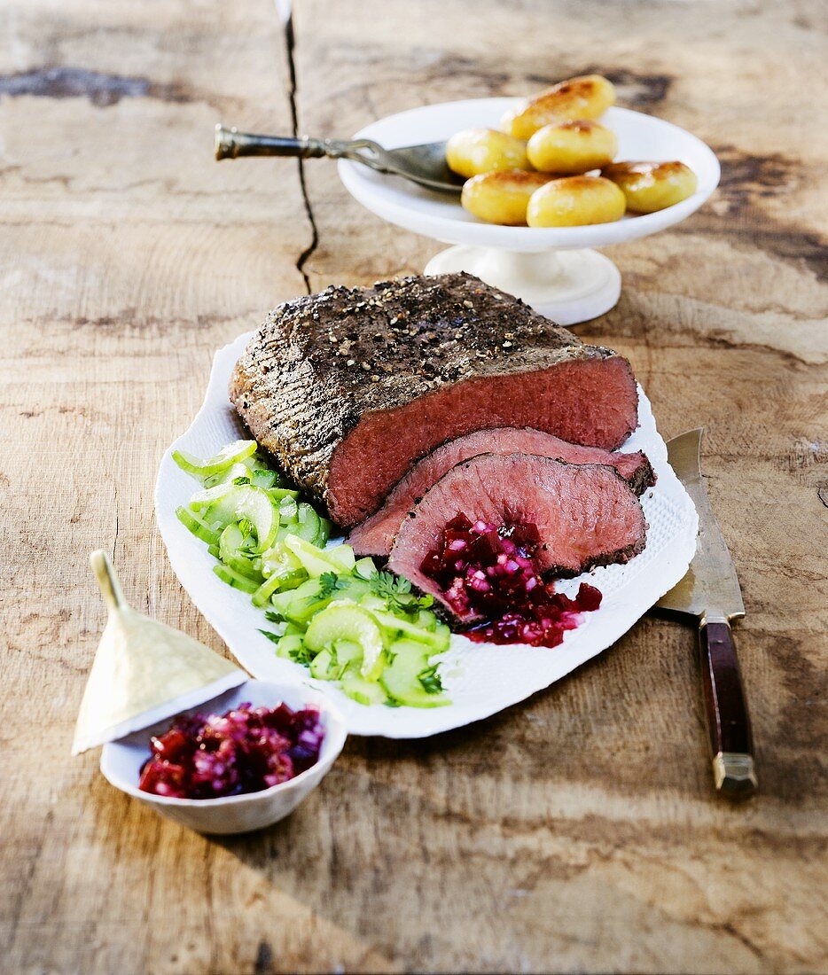 Roast beef with cucumber salad, salsa and potatoes