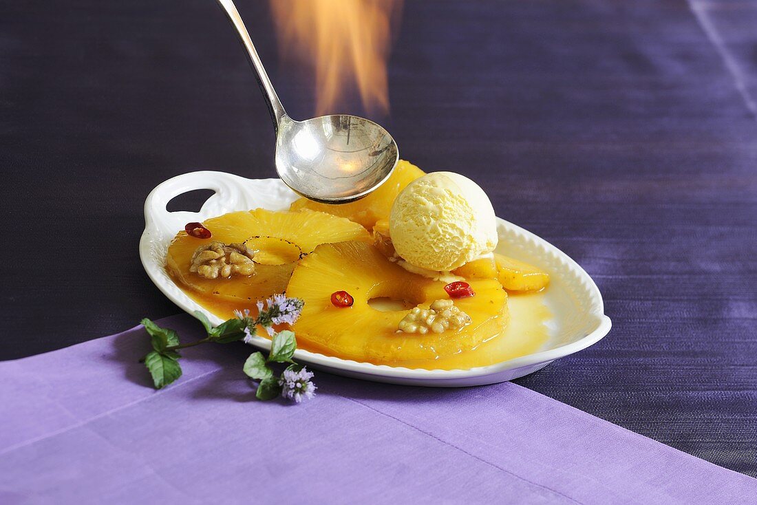 Flambéed pineapple with vanilla ice cream