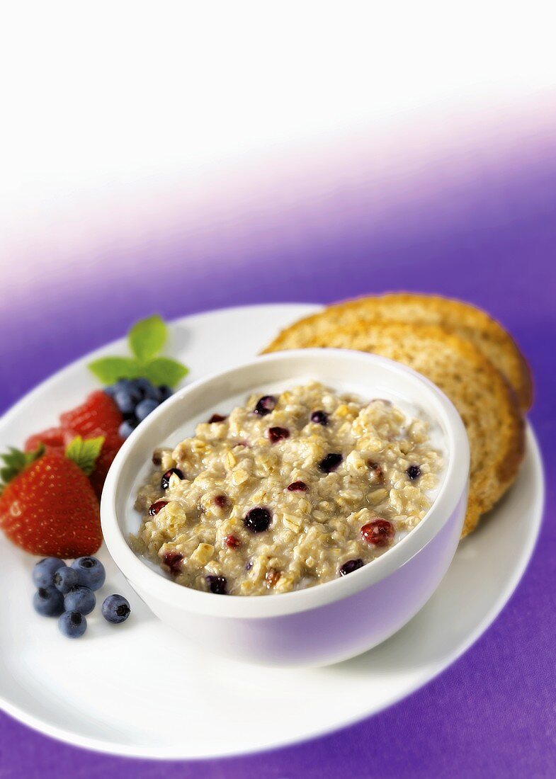 A bowl of porridge with mixed berries
