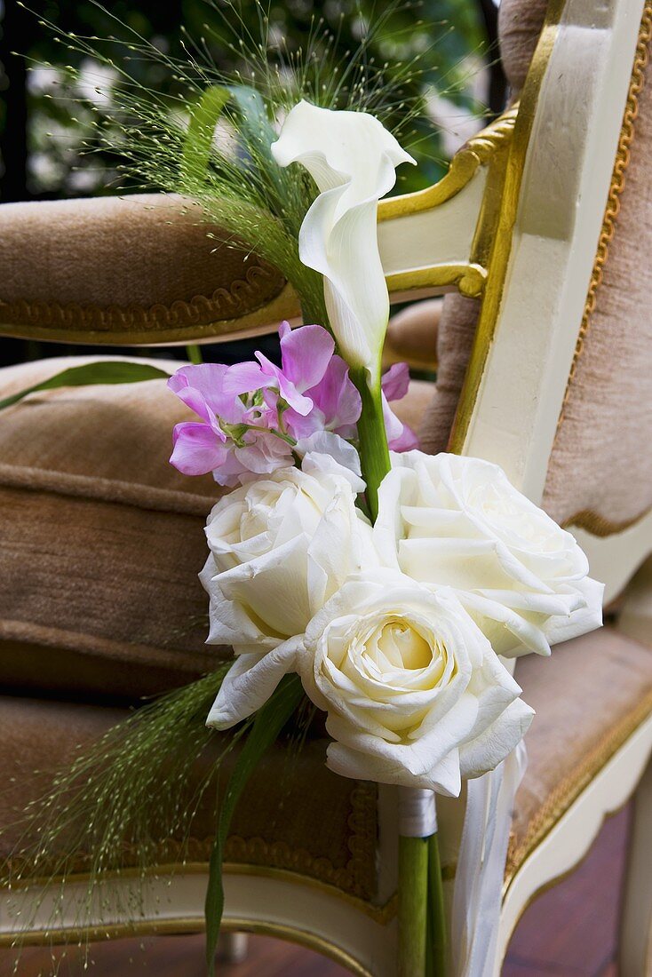 Arrangement of white roses and calla lily