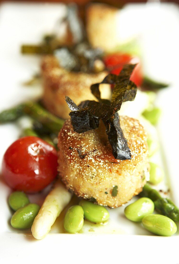 Crab cakes with seaweed and vegetables