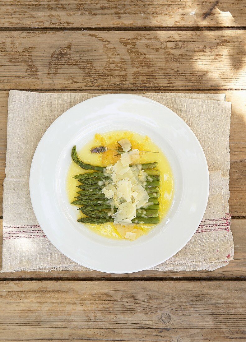 Green asparagus with sauce & cheese shavings (overhead view)