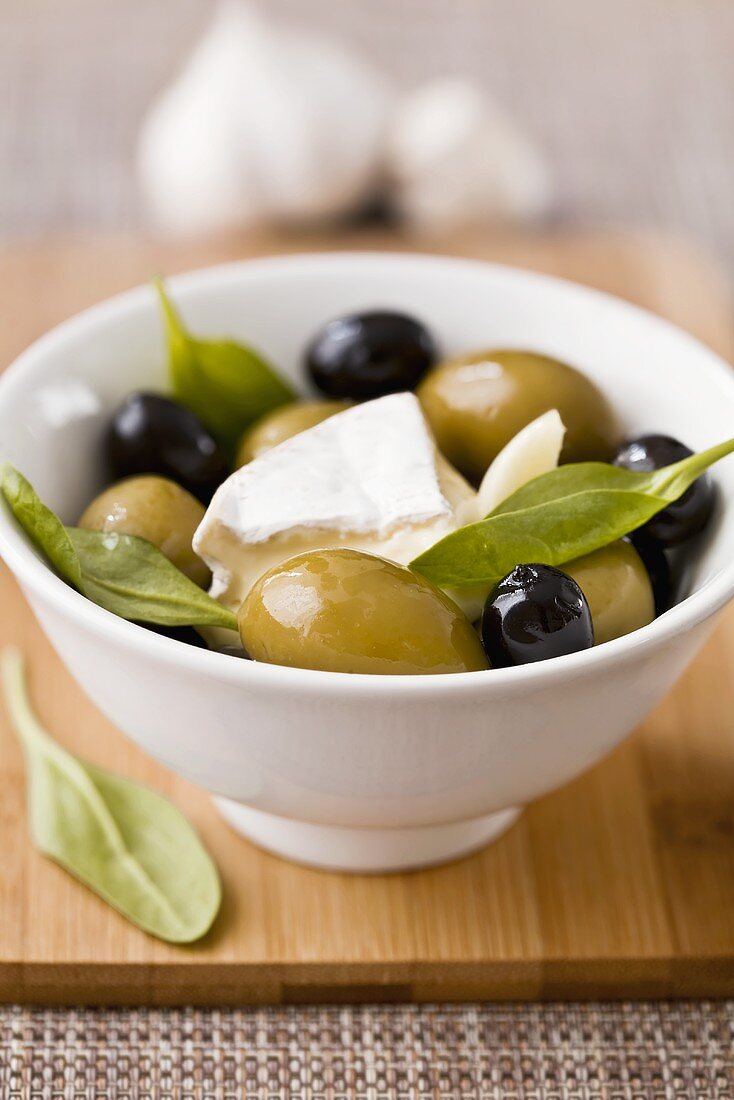 Marinated olives with Camembert and basil