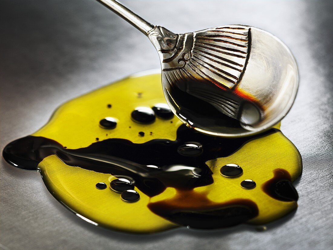 Olive oil and balsamic vinegar with spoon