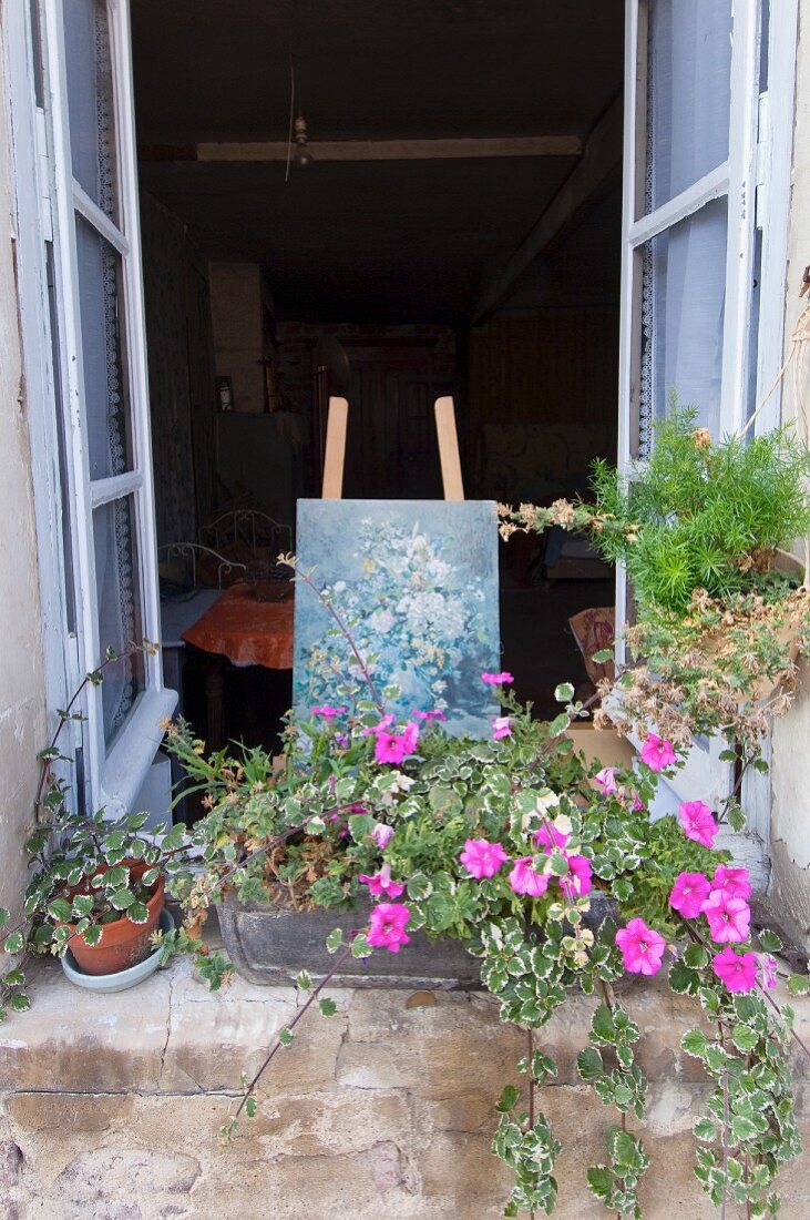 Open window in a romantic house with easel