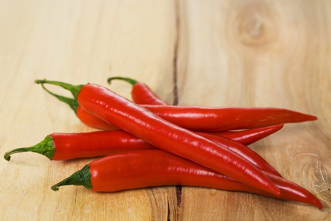 Red chillies on wooden background