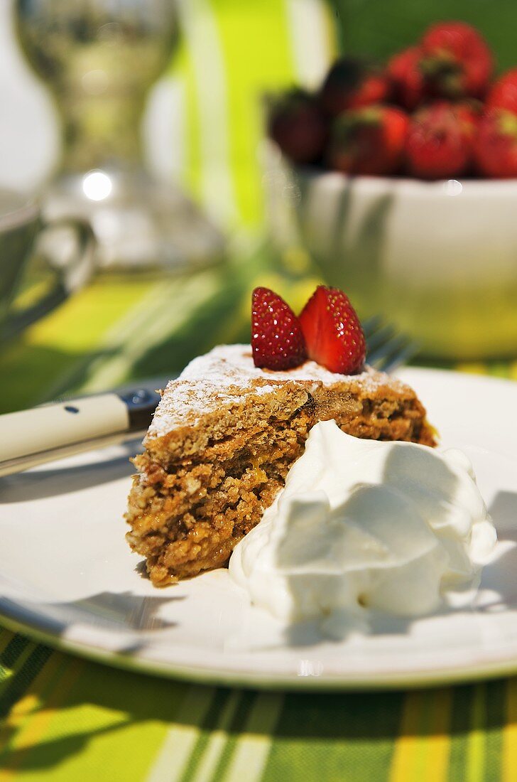 Honey and walnut cake with fresh strawberries and cream