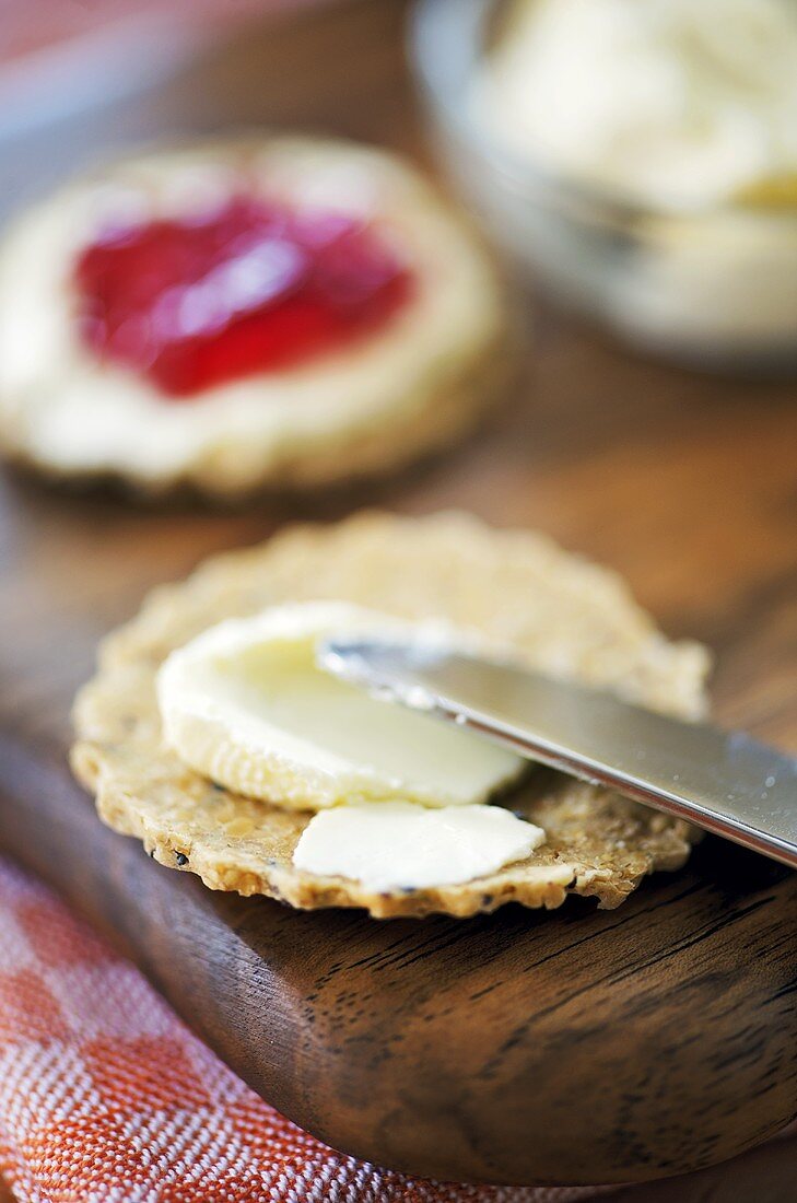 Spreading oatcake with soft cheese