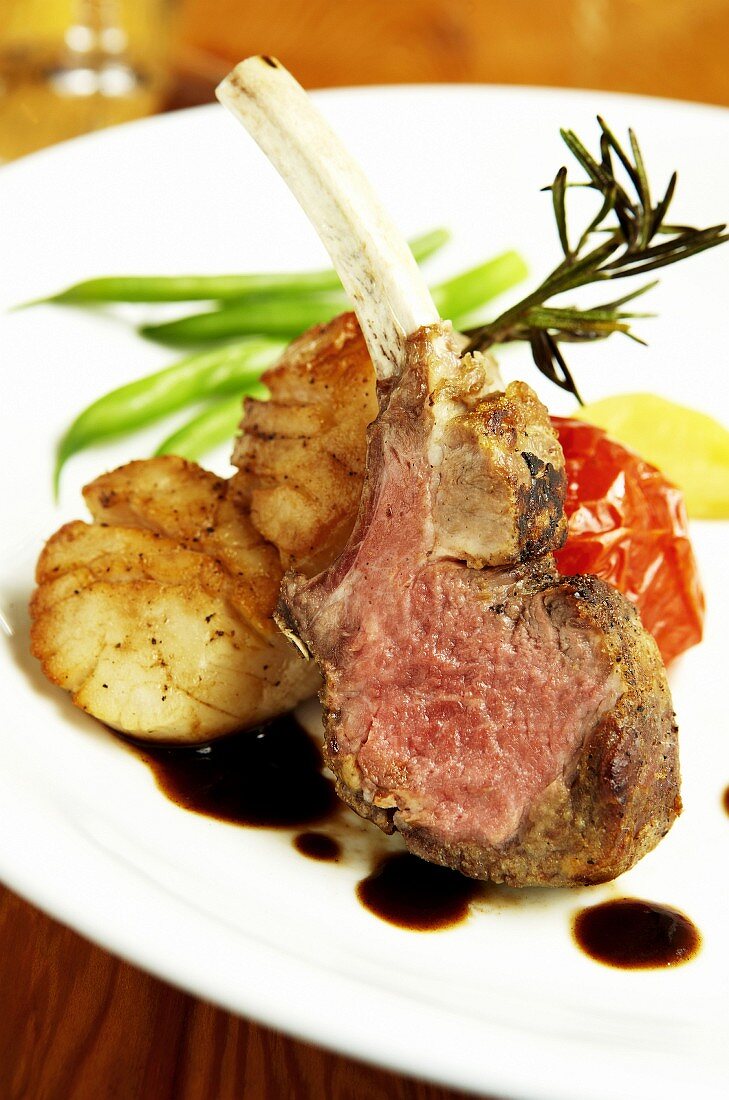 Lamb chop with scallops and vegetables