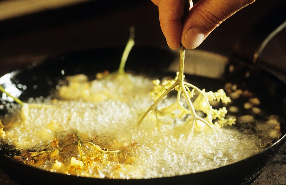 Making elderflower fritters