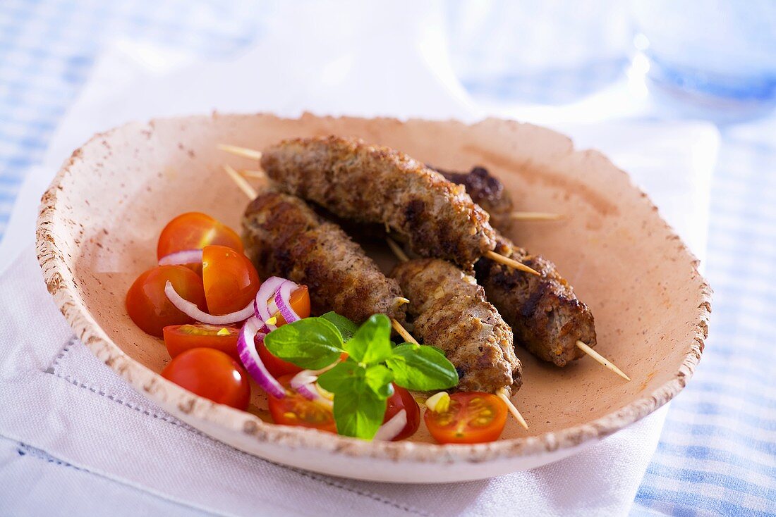Lamb skewers with tomato salad