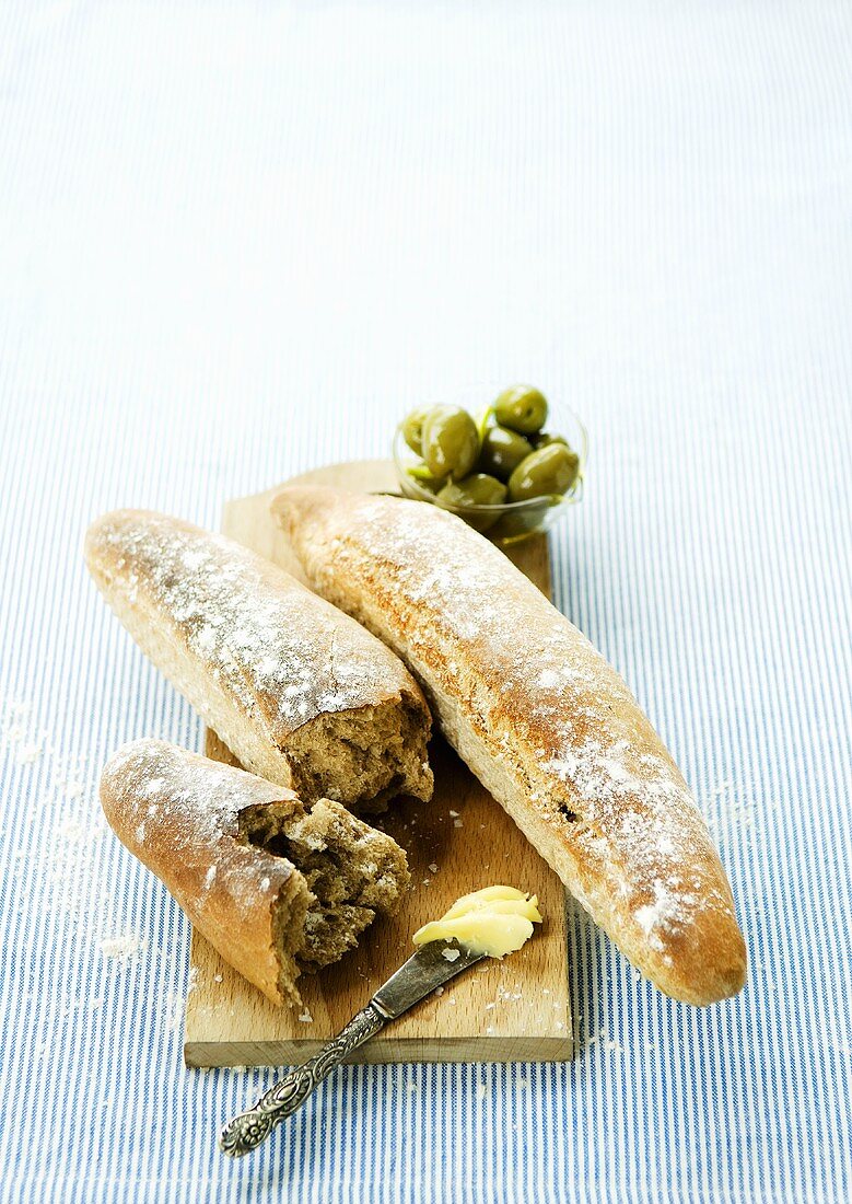 Bread sticks with butter and olives