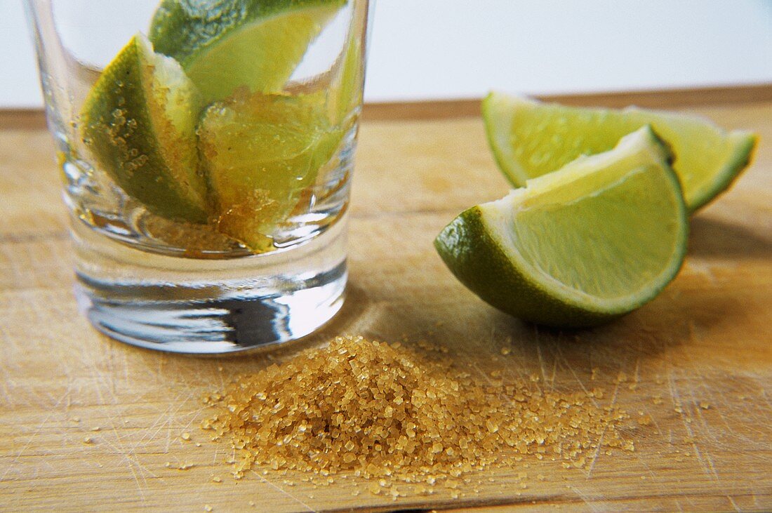 Ingredients for caipirinha: limes and brown sugar