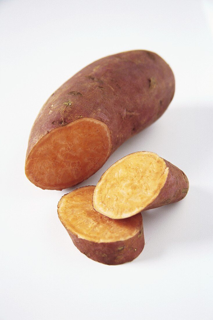 A sweet potato, partly sliced